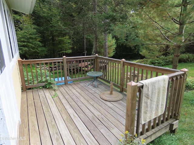 wooden deck with a lawn