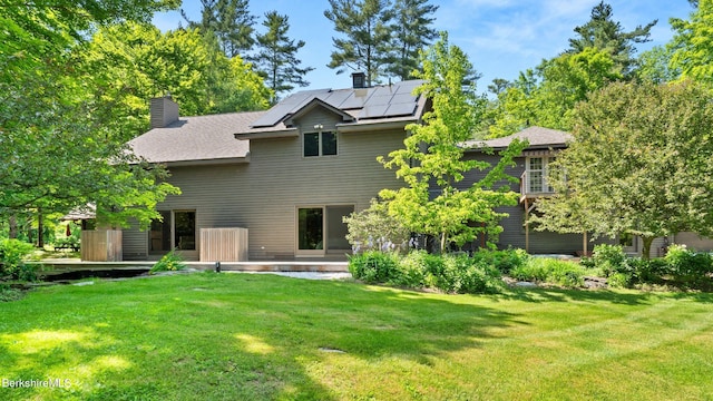 173 Hillsdale Rd, Egremont, MA 01258 - rear view of property featuring solar panels, a lawn, a chimney, and a patio area