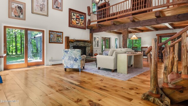 173 Hillsdale Rd, Egremont, MA 01258 - living room featuring a baseboard heating unit, wood-type flooring, a towering ceiling, healthy amount of natural light, and beamed ceiling