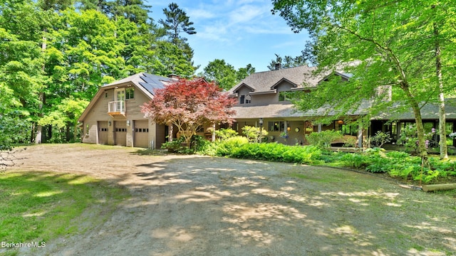 173 Hillsdale Rd, Egremont, MA 01258 - view of front facade featuring driveway, roof mounted solar panels, and a garage
