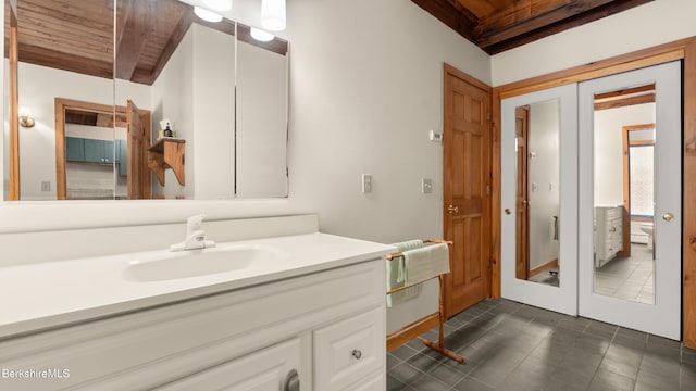 173 Hillsdale Rd, Egremont, MA 01258 - bathroom with a wood ceiling with exposed beams, vanity, french doors, and tile patterned floors
