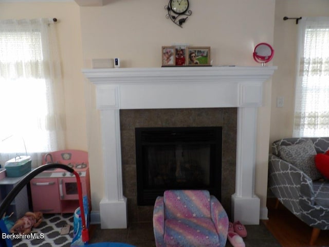 interior details featuring a tiled fireplace