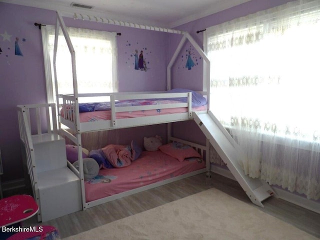 bedroom with visible vents and wood finished floors