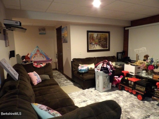 living area featuring a paneled ceiling