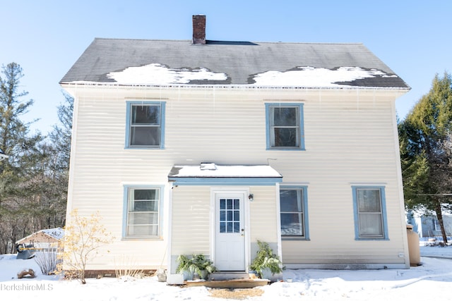 view of snow covered rear of property