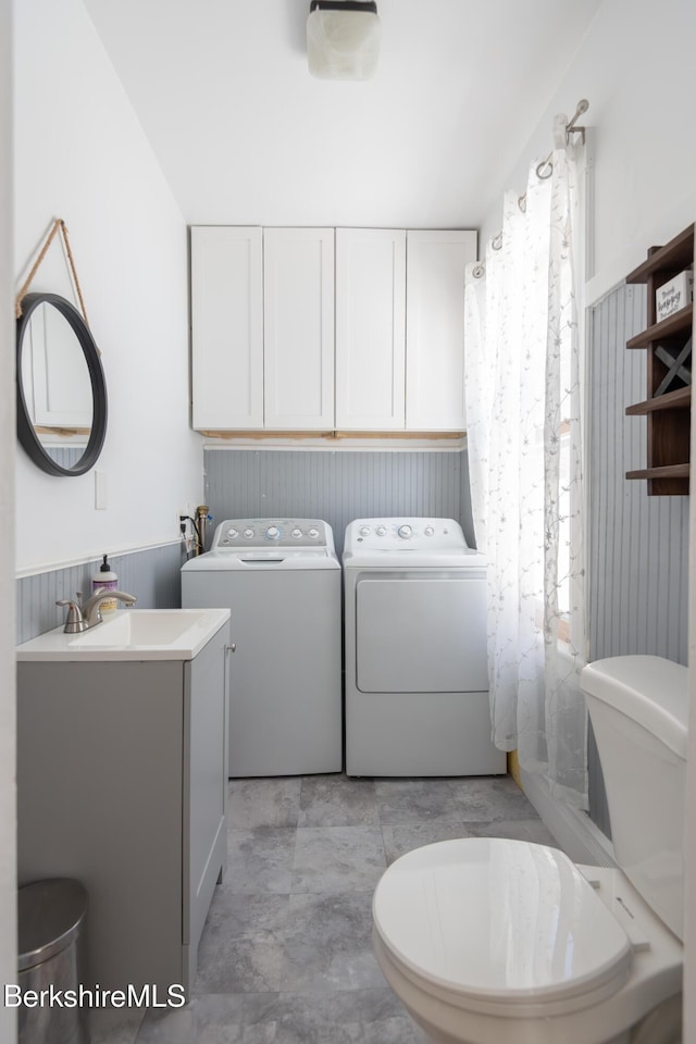 laundry area featuring independent washer and dryer and sink