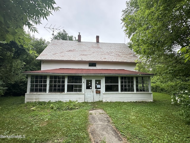 425 Barbour St, North Adams, MA 01247 - view of front facade featuring a sunroom, a chimney, and a front yard