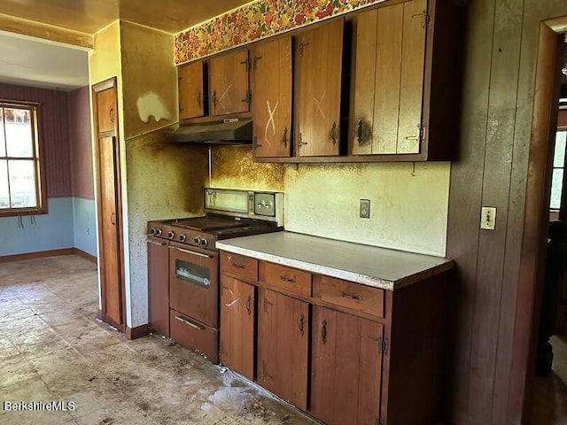 425 Barbour St, North Adams, MA 01247 - kitchen with range, under cabinet range hood, brown cabinetry, and light countertops