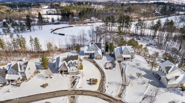 snowy aerial view with a residential view