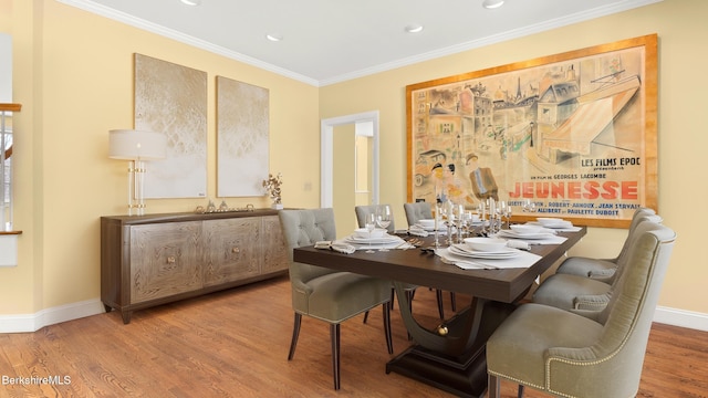 dining space featuring ornamental molding, recessed lighting, baseboards, and wood finished floors