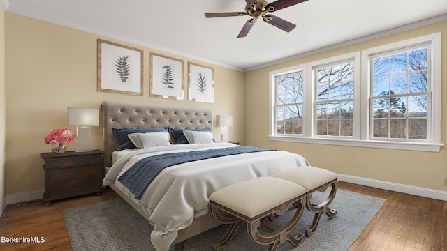 bedroom featuring crown molding, hardwood / wood-style floors, and baseboards