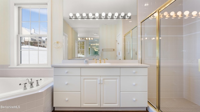 bathroom featuring a garden tub, a shower stall, and vanity