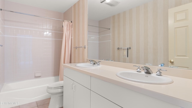 bathroom featuring shower / bath combination with curtain, a sink, toilet, and tile patterned floors