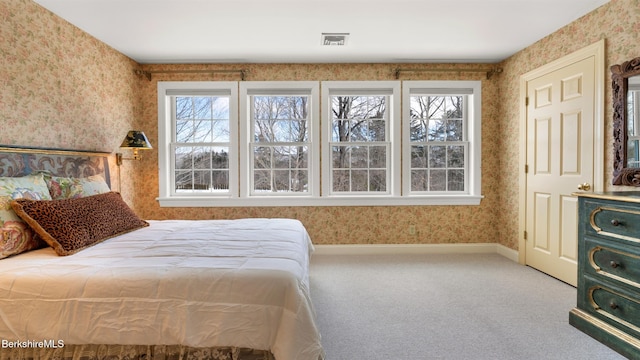 bedroom featuring baseboards, carpet, visible vents, and wallpapered walls