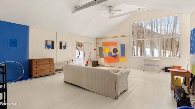 living room featuring vaulted ceiling, ceiling fan, and wood finished floors