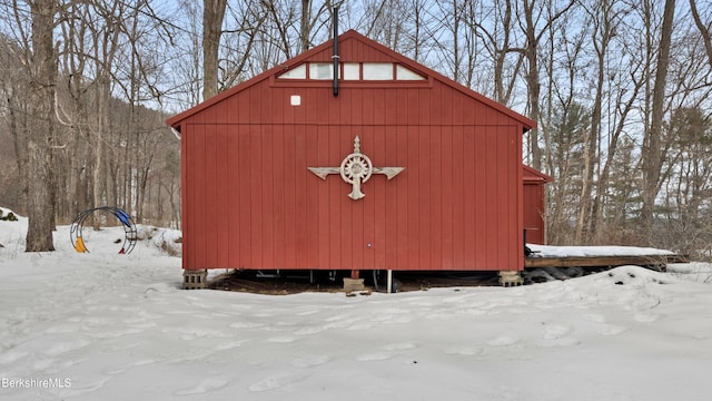 snow covered structure featuring an outdoor structure