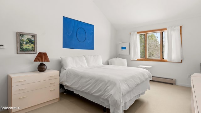 bedroom featuring lofted ceiling, a baseboard radiator, and light colored carpet