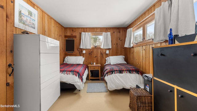 carpeted bedroom with wood walls