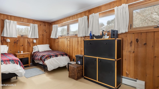 bedroom with carpet flooring, wooden walls, and baseboard heating