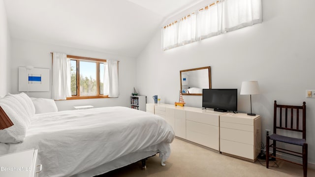 bedroom featuring light carpet and vaulted ceiling