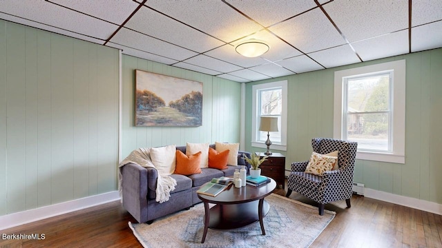 208 Columbia St, Adams, MA 01220 - sitting room with a baseboard radiator, a drop ceiling, hardwood / wood-style flooring, and baseboards