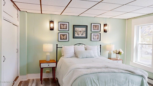 208 Columbia St, Adams, MA 01220 - bedroom with a paneled ceiling, multiple windows, baseboard heating, and wood finished floors