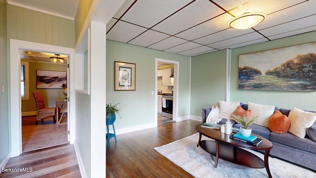 208 Columbia St, Adams, MA 01220 - living area featuring wood walls, wood finished floors, and baseboards