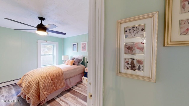 208 Columbia St, Adams, MA 01220 - bedroom featuring a baseboard radiator, wood finished floors, and a ceiling fan