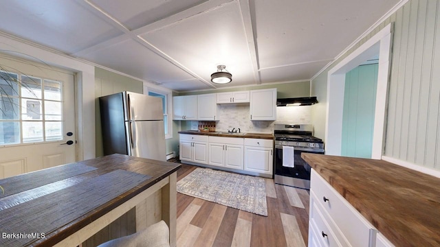 208 Columbia St, Adams, MA 01220 - kitchen featuring tasteful backsplash, light wood-style flooring, wood counters, appliances with stainless steel finishes, and ventilation hood