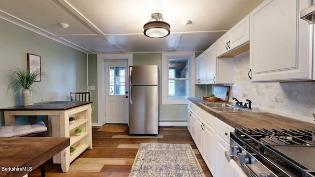208 Columbia St, Adams, MA 01220 - kitchen with tasteful backsplash, a baseboard radiator, stainless steel appliances, a sink, and dark wood-type flooring
