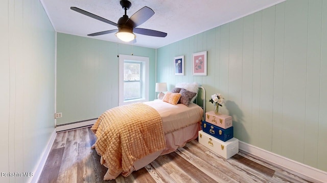 208 Columbia St, Adams, MA 01220 - bedroom featuring wood finished floors, ceiling fan, baseboard heating, and baseboards