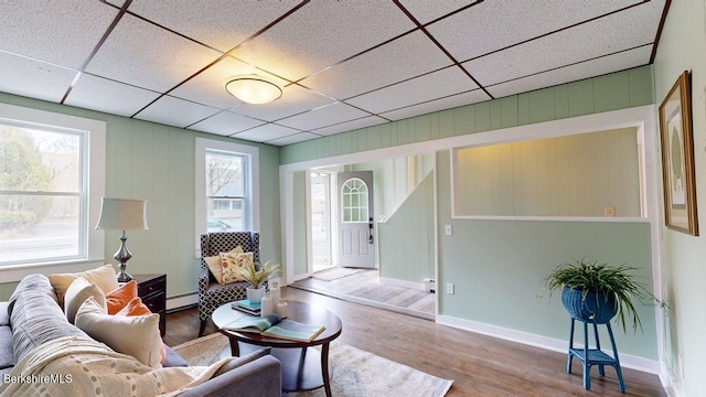 208 Columbia St, Adams, MA 01220 - living area with a paneled ceiling, baseboards, wood finished floors, and a baseboard radiator