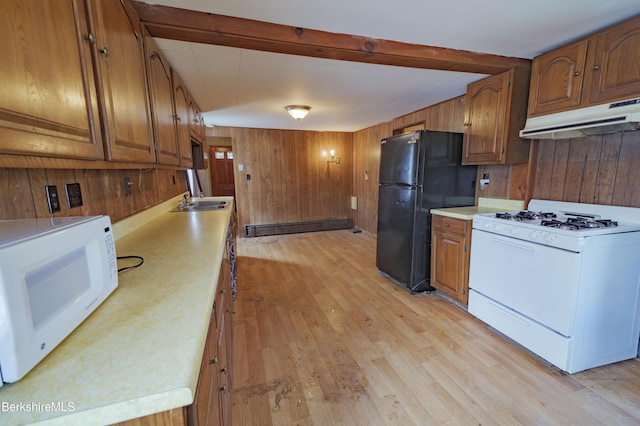 kitchen featuring wood walls, beamed ceiling, a baseboard radiator, white appliances, and light wood-type flooring