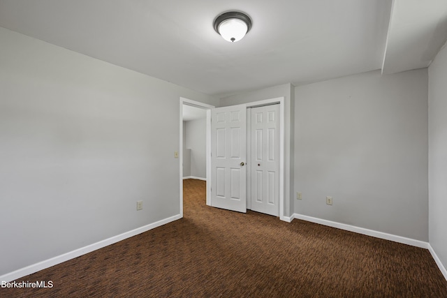 881 Holmes Rd, Pittsfield, MA 01201 - unfurnished bedroom with baseboards, dark colored carpet, and a closet