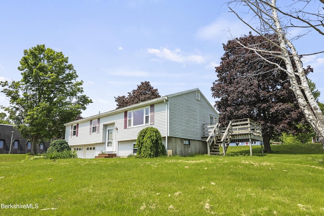 881 Holmes Rd, Pittsfield, MA 01201 - bi-level home featuring an attached garage, a wooden deck, and a front lawn