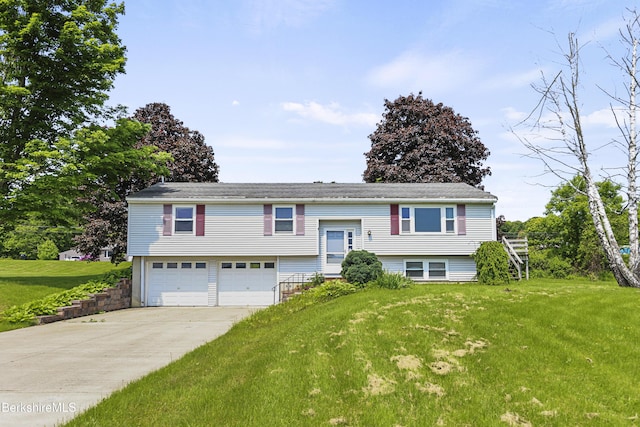 881 Holmes Rd, Pittsfield, MA 01201 - raised ranch with a garage, concrete driveway, and a front lawn