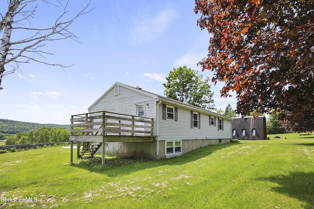 881 Holmes Rd, Pittsfield, MA 01201 - rear view of house featuring stairway, a deck, and a lawn
