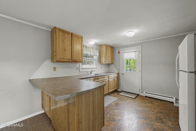 881 Holmes Rd, Pittsfield, MA 01201 - kitchen with freestanding refrigerator, a baseboard heating unit, a peninsula, decorative backsplash, and baseboards