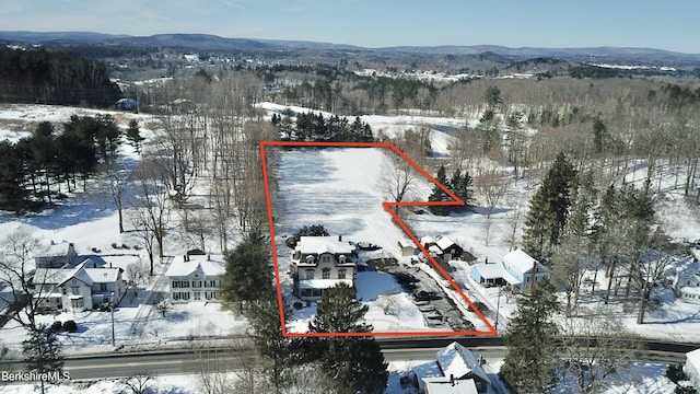 snowy aerial view featuring a mountain view