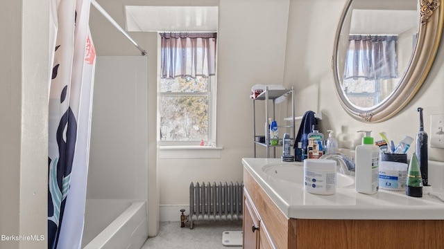 full bathroom featuring radiator heating unit, shower / bath combo with shower curtain, and vanity