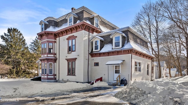 second empire-style home with entry steps and mansard roof