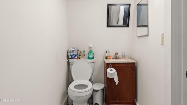 half bath featuring toilet and vanity