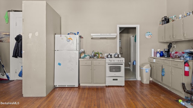 kitchen featuring light countertops, white appliances, hardwood / wood-style flooring, and under cabinet range hood