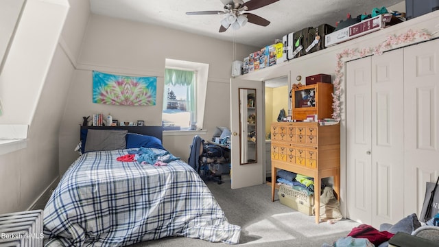 bedroom featuring a ceiling fan, carpet, and a closet