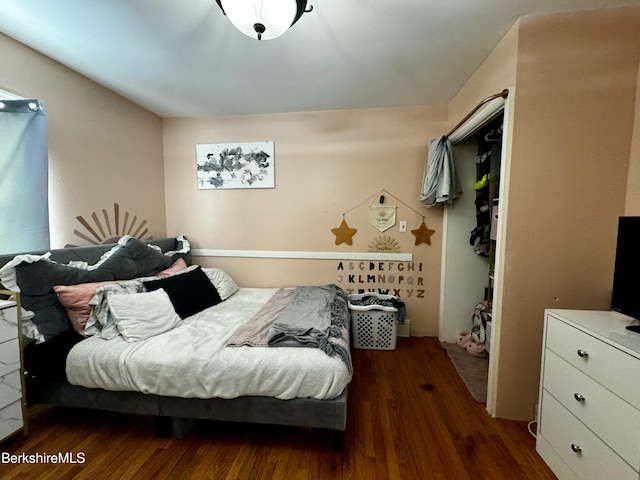 bedroom with dark hardwood / wood-style floors