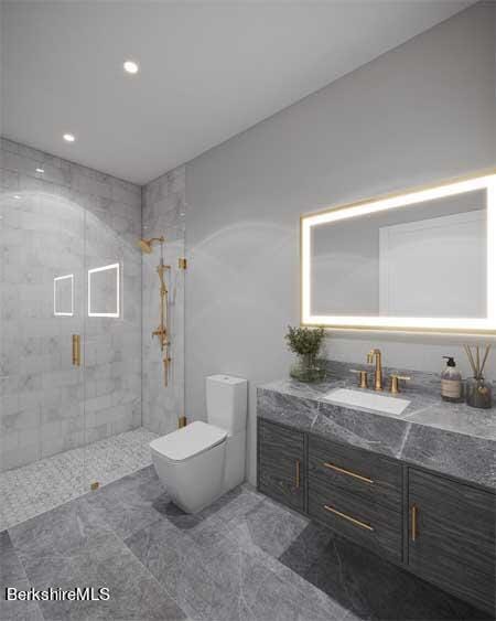 bathroom with vanity, toilet, and a shower with shower door