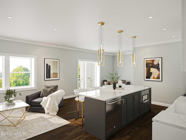 kitchen featuring light stone counters, a center island, and hanging light fixtures