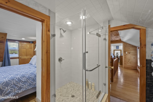 123 Bock Way, New Marlborough, MA 01230 - bathroom featuring connected bathroom, wood finished floors, lofted ceiling, a shower stall, and wood walls