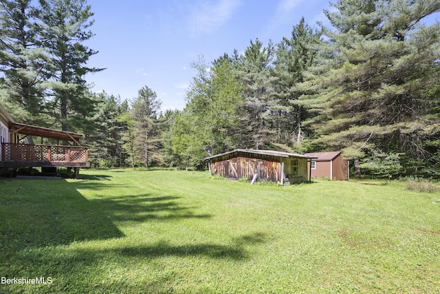 159 Black Brook Rd, Savoy, MA 01256 - view of grassy yard with a forest view, a deck, and a storage shed