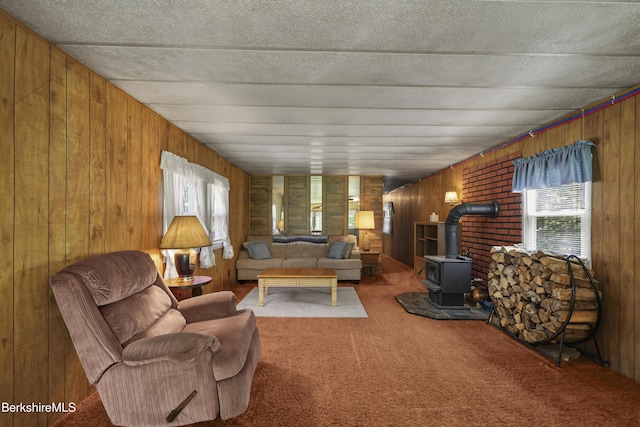 159 Black Brook Rd, Savoy, MA 01256 - carpeted living room featuring plenty of natural light, a wood stove, and wooden walls